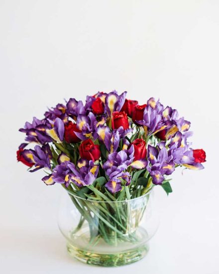 IRIS & RED ROSES IN SHORT GLASS VASE